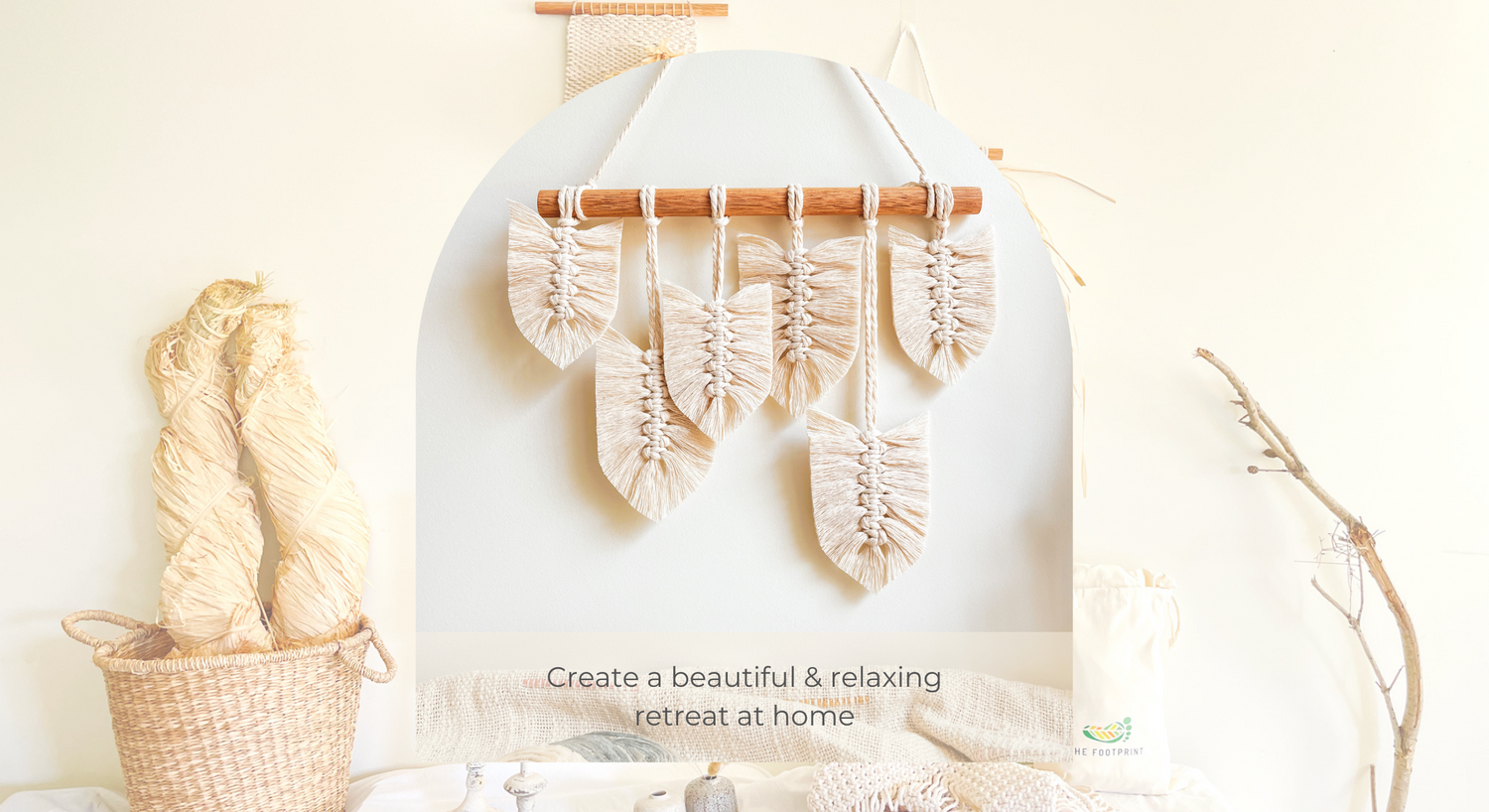 The Footprint - Boho coastal decor store banner with natural raffia and macrame feather wall hagning with the tag line " Create a beautiful and relaxing retreat at home"