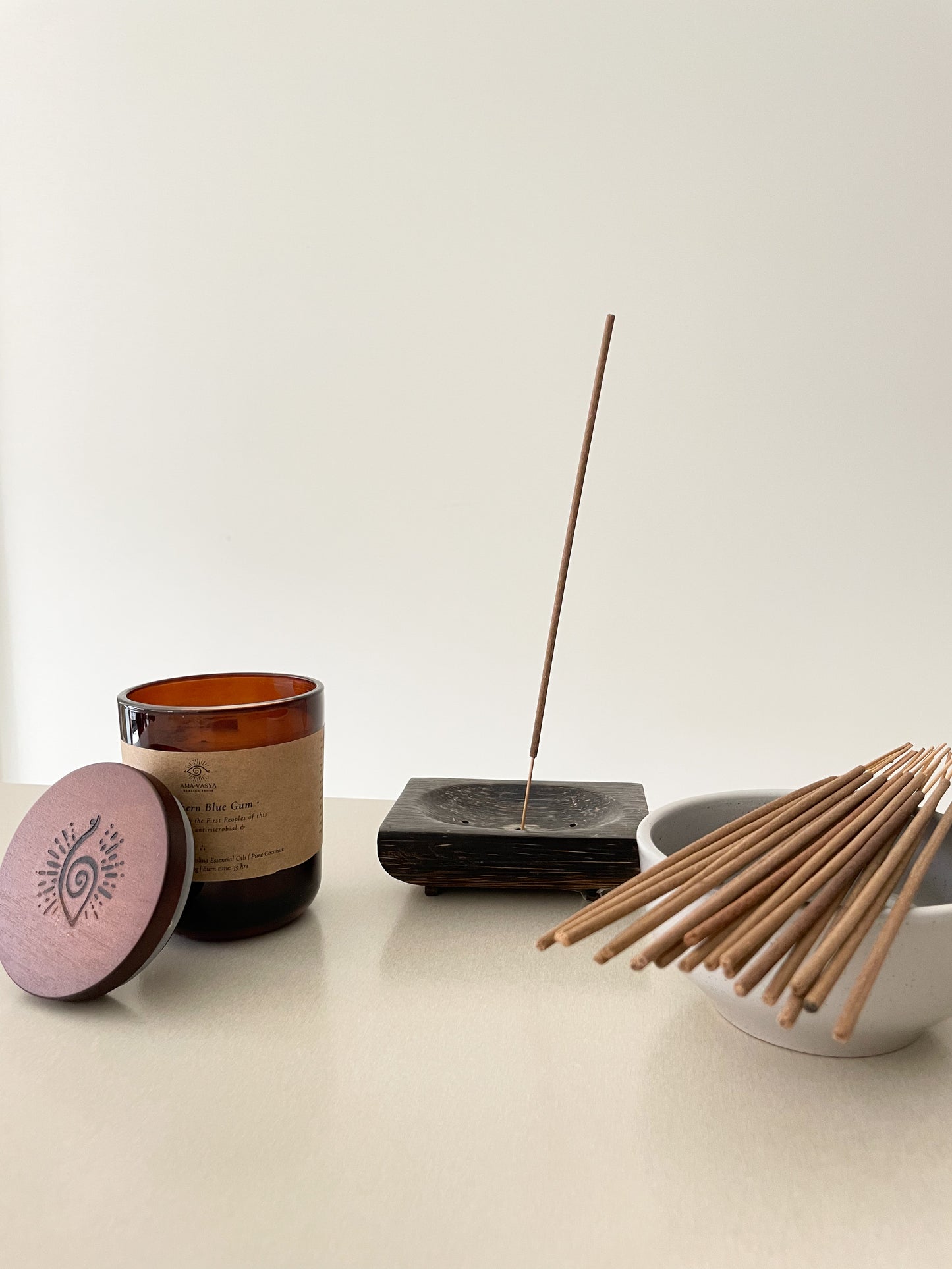 Natural soywax candle and natural incense sticks on a table