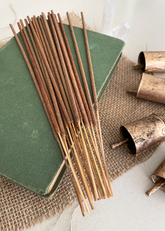 Vegan natural incense sticks handrolled in Australia styled on a vintage book