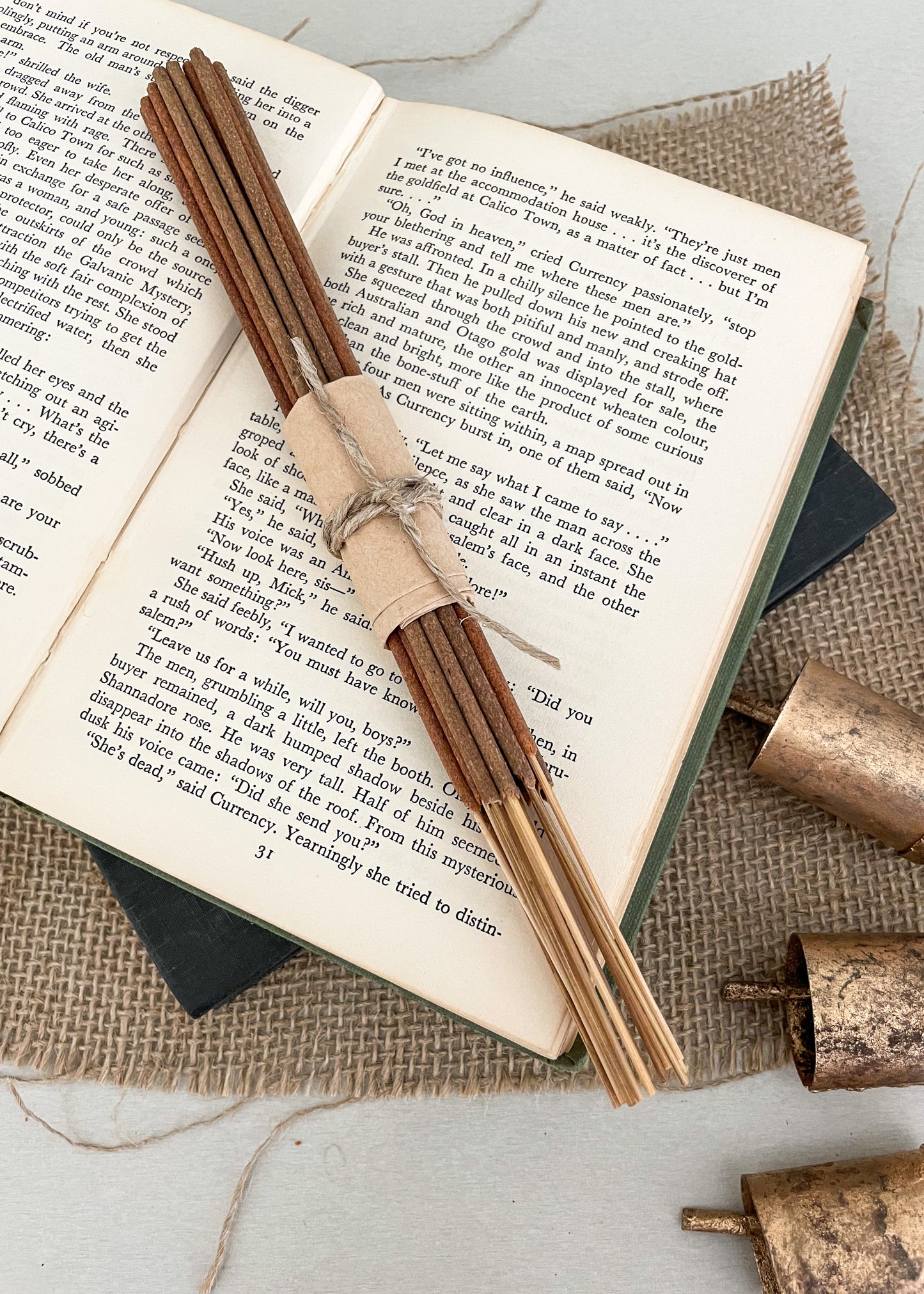 Bundle of vegan natural incense sticks handrolled in Australia styled on a vintage book