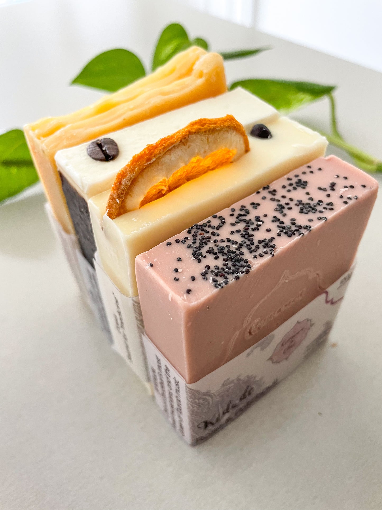 Colourful natural handmade artisan soaps bundle displayed on a table. 