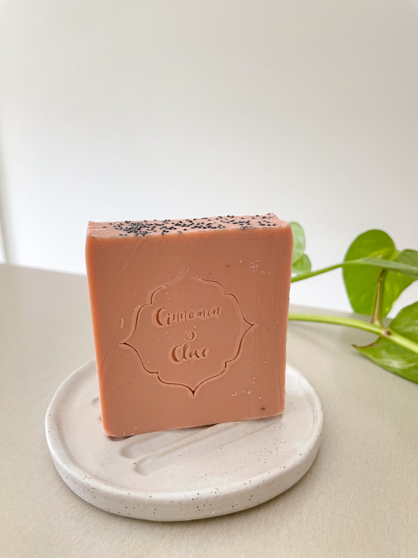 Kidude handmade natural soap placed on a ceramic soap dish