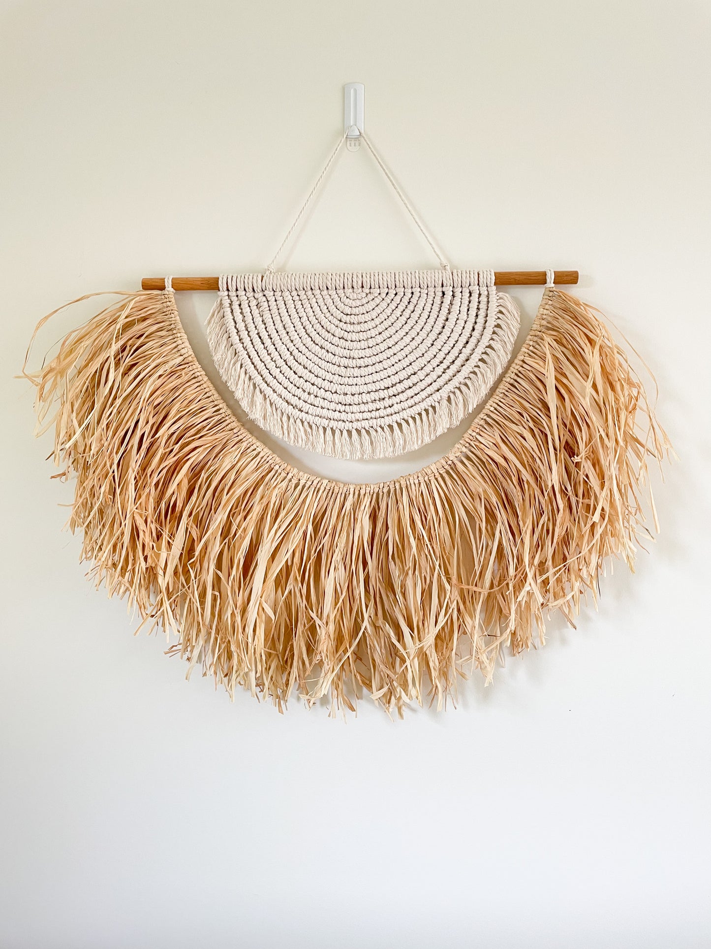 Large macrame and raffia wall hanging hanged on a wall