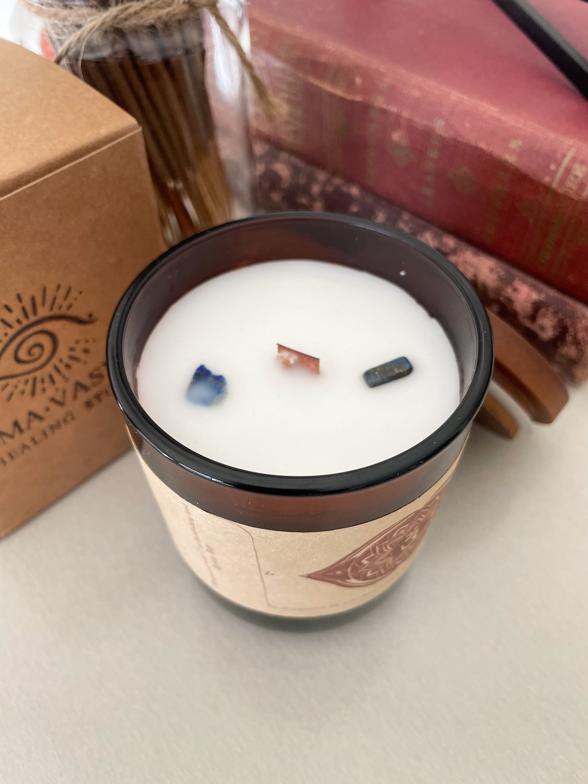 Third Eeye Chakra meditation candle with crystals styled with candle packaging, spiritual books and incense