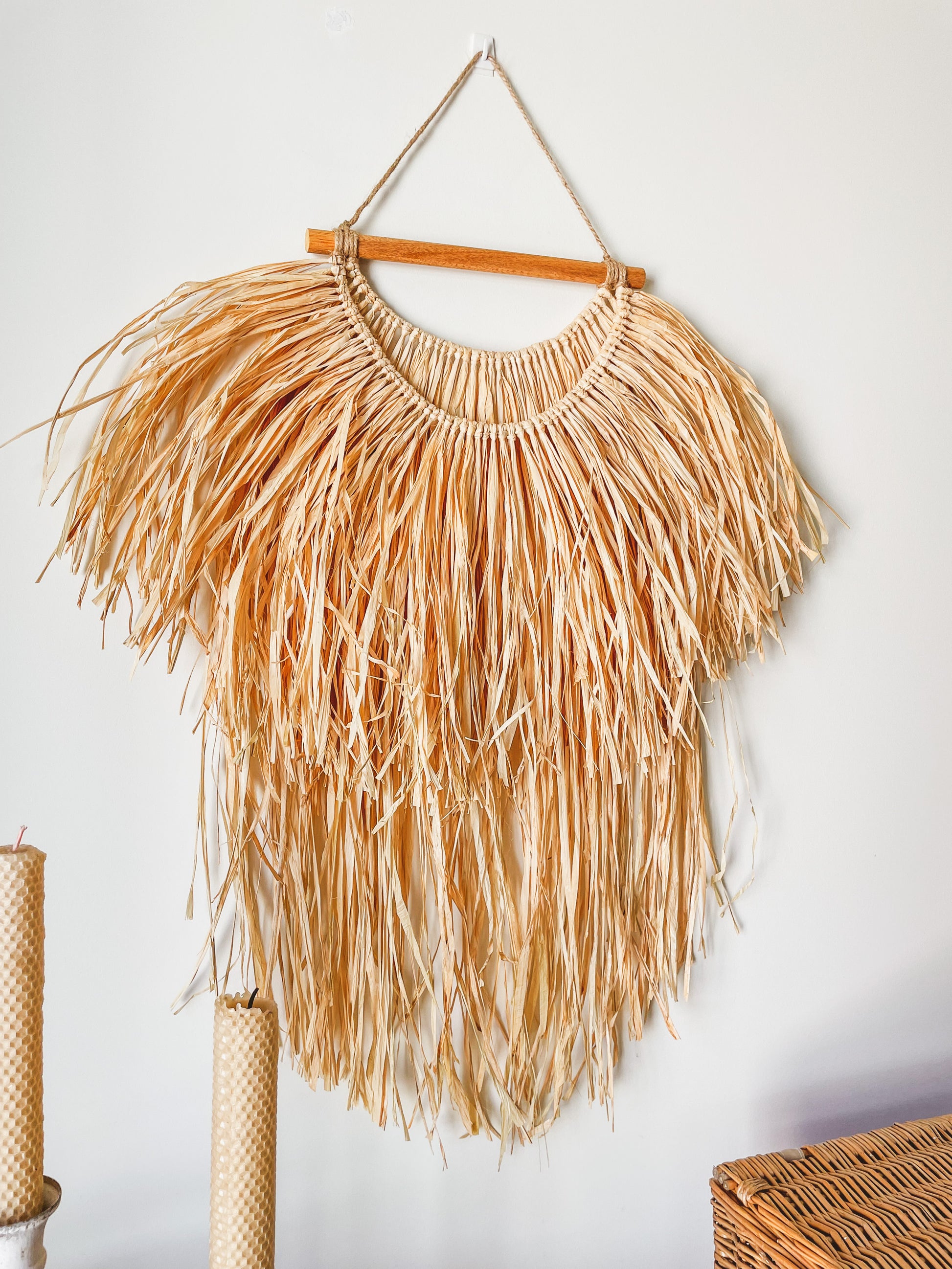 Side view of a raffia wall hanging hanged on a wall 