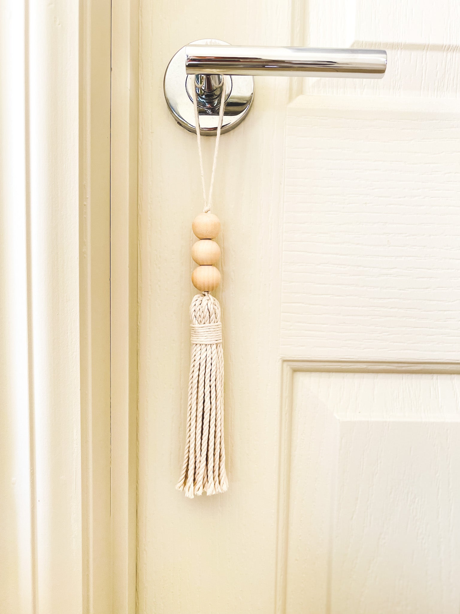Beaded macrame tassel hanged on a door handle