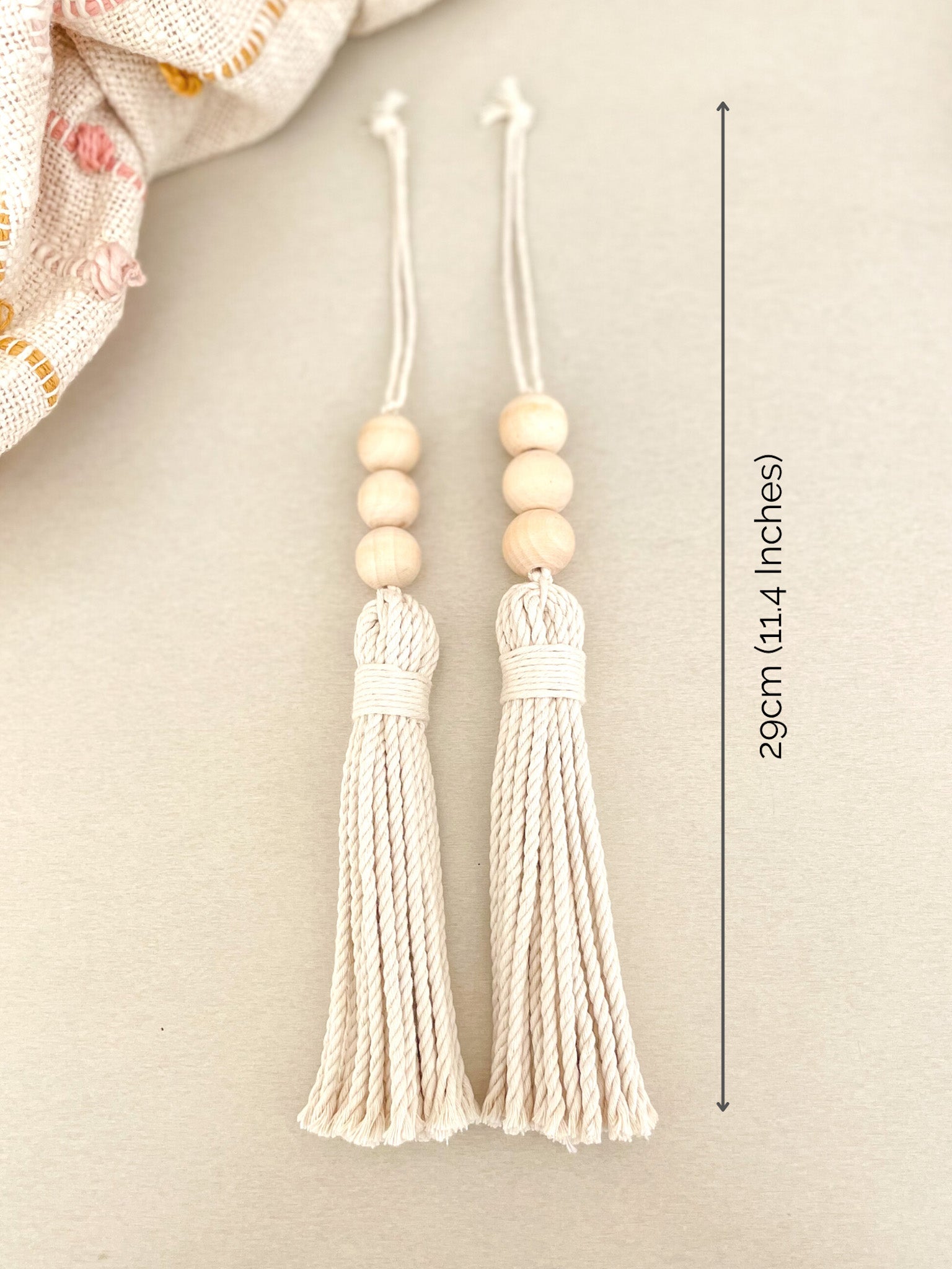 Two beaded macrame tassels with dimensions marked. 20cm (11.4 Inches) long with the hanging rope. 