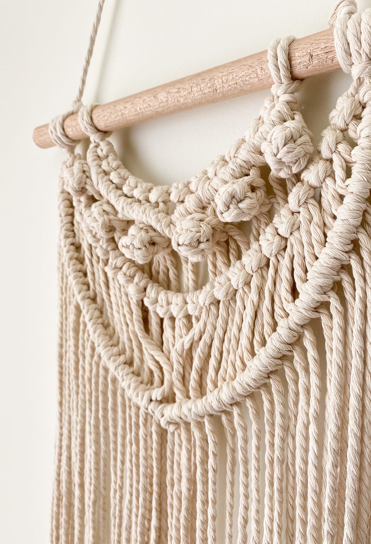 Side view of a tassel wall hanging hanged on the wall